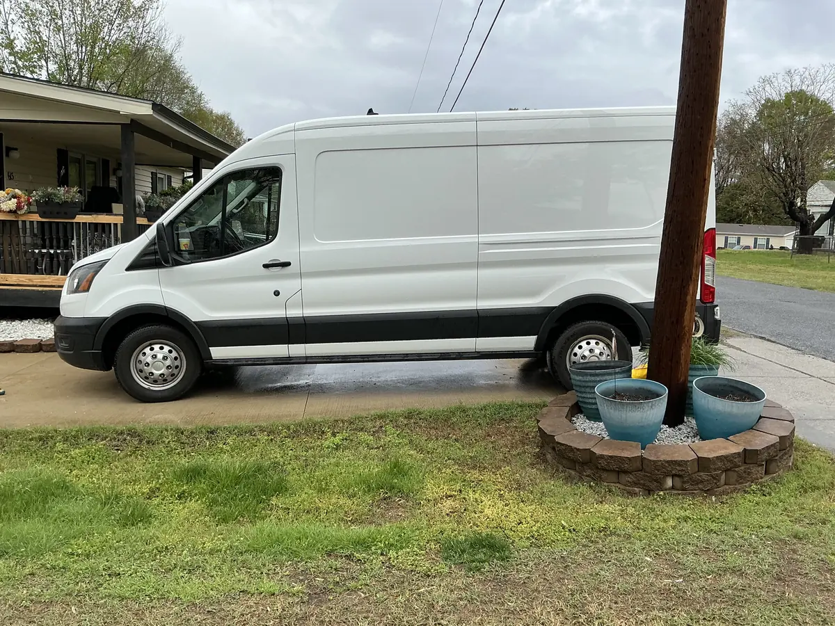 Lil Man Big Van's white Sprinter cargo van, driver side.